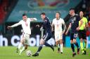 England's Mason Mount (left) and Scotland's Callum McGregor battle for the ball during the UEFA Euro 2020 Group D match at Wembley Stadium, London. Picture date: Friday June 18, 2021.