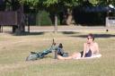 A man sunbathes this morning (July 11) in Kensington Gardens, south London, as Britons are set to sizzle on what could be the hottest day of the year so far