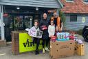 Grace Porter, 10, Danny-Lee Finch, Holly Delaney, nine, Mark Craven and Liz Delaney, five, with donated items outside Romford gym VIP HQ Essex.