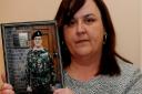 Karen LeSurf with a picture of her dad George Clarke.