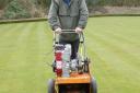 Groundsman Steve Gildersleeve aerating the greens at King George's Playing Fields, home of Brentwood Bowling Club.
