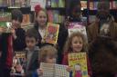 Children from Broadford Primary School pick out their favourite books to mark World Book Day.