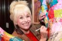 Barbara Windsor signs one of Richard's donations for a 2014 hospice auction