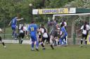 Romford faced a packed Halstead defence as Hassan Nalbant wins a header. Picture: ALAN BLACKHOLLY