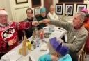 Guests pull crackers at French's Cafe in Hornchurch on Christmas Day.