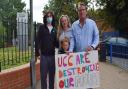 Max Reader (l) was at the protest with his mother Lisa, father Steve (r) and eight-year-old brother James (front).