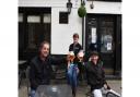 Barry Couch and Jay Guilder enjoying a pint outside of The Lamb, pictured with pub manager Tracy Chillingworth