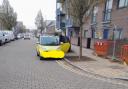 A car parked on yellow lines outside the school