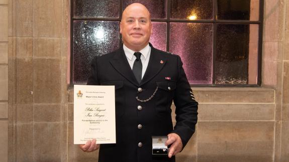 Romford Recorder: Sgt Ian Bargus proudly holds up his certificate and pin. Romford Recorder: Sgt Ian Bargus proudly holds up his certificate and pin.