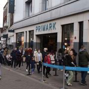 A queue of shoppers form outside Primark in Romford