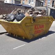 The skip on the road in St Chad's Gardens in Chadwell Heath