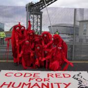 The Red Rebel Brigade stage a protest along the perimeter of the Cop26 summit