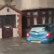 An image of a car partially submerged as flooding hits Havering and Dagenham during a storm that saw a 