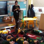 A reception class at Crownfield Infants try out a mindfulness activity