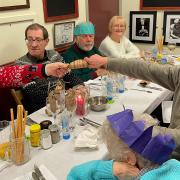 Guests pull crackers at French's Cafe in Hornchurch on Christmas Day.