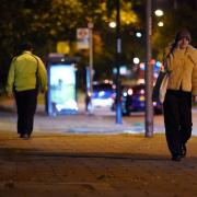 A woman walking after dark on Poynders Road in Clapham, south London, close to where Sarah Everard was abducted from the street by being falsely arrested by police officer Wayne Couzens in March. Picture date: Friday October 1, 2021.
