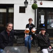 Barry Couch and Jay Guilder enjoying a pint outside of The Lamb, pictured with pub manager Tracy Chillingworth