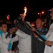 Alby pictured holding the Paralympic torch with Glynn Bentley, the assistant co-ordinator of the pupil administration and support service at Shenfield High School where Alby was a pupil.