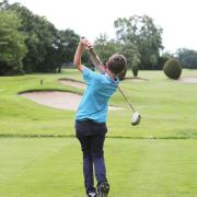 A youngster tees off at Romford Golf Club.