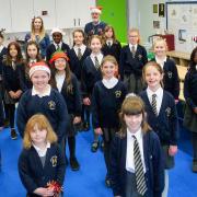 Hogarth Primary School's choir with (back row left to right) headteacher Nera Butcher, music coordinator Hannah Herbert and Geoff Bagwell.