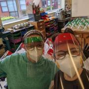 Teacher Lee Doe and Samantha Cadman are creating face shields from class room materials. PIcture: Lee Doe