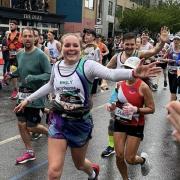 Emily Defroand and brother Alex wave while running the London Marathon