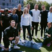 Adam Peaty (white shirt) faces the camera with others at an event hosted by Bridgestone. Image: Bridgestone