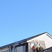 Firefighters tackle the roof fire