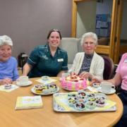 Leonard Lodge residents and a volunteer enjoying the Easter period with some cake baking