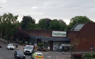 Police tape has sealed off an area outside Waitrose and Tudor Gardens in Upminster