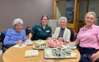 Leonard Lodge residents and a volunteer enjoying the Easter period with some cake baking