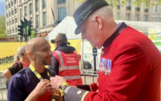 Shreeraj Laturia receiving his medal from a Chelsea Pensioner